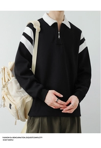 Close-up detail of a men's black long sleeve polo shirt with white stripes and half-zip