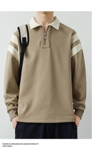 Close-up of khaki polo sweatshirt with quarter zipper and white stripes on sleeves