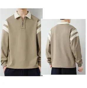 Detail of khaki men's long sleeve polo with zip collar and white arm stripes
