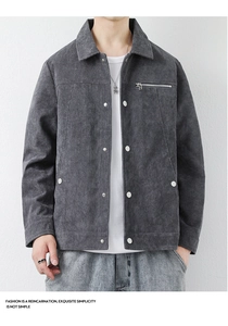 Detail of dark gray corduroy jacket showing texture, metal buttons, and zipper pocket