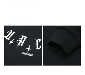 Detail of white Gothic lettering print and elastic ribbed cuffs on a black hoodie
