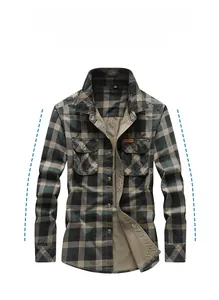 Detail of green plaid cotton shirt showing chest pockets and free spirit label texture