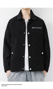 Detailed close-up of men's black corduroy jacket showing silver snap buttons and zipper pocket