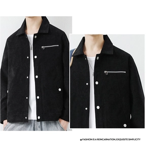 Detail of men's black corduroy jacket showing ribbed texture, metal zipper and lapel