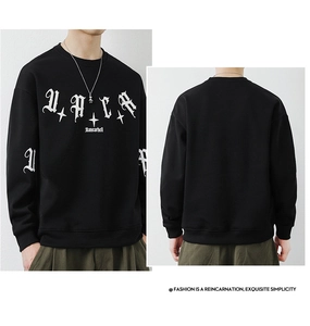 Detail view of black men's crewneck sweatshirt with white gothic typography and ribbed cuffs