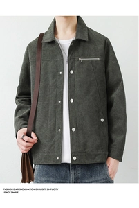 Close-up of dark green corduroy jacket texture with metal zipper and snap buttons