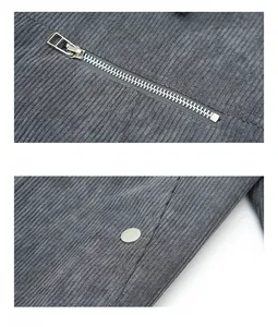 Detail of gray corduroy jacket featuring silver metal zipper and snap button pockets
