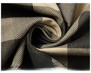 Macro shot of black and yellow buffalo check twill fabric texture for men's shirt