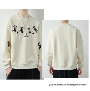 Detailed views of beige oversized sweatshirt showing gothic font print and ribbed cuffs