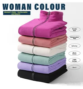 Detail of stacked polar fleece jackets showing zip-up standing collars and soft texture