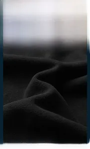Detailed close-up showing the soft texture of black polar fleece fabric with anti-pilling finish