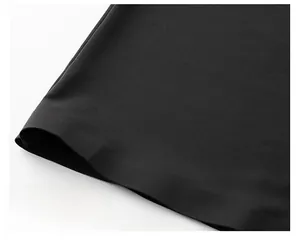 Détail de l'ourlet lisse et de la texture du tissu en soie glacée sur t-shirt noir
