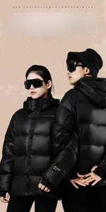 Detail showing the windproof shiny fabric and signature arm badge on this black down jacket