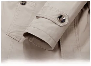 Close-up of khaki casual jacket cuff with marble pattern button and twill fabric texture