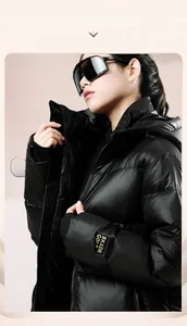 Close-up of black hooded down jacket featuring a bright yellow BKADR woven sleeve badge