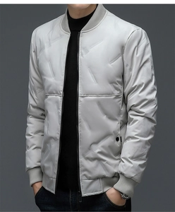 Macro detail of men's light grey quilted jacket featuring textured embossing and ribbed cuffs