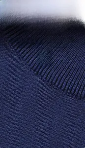 Detailed macro view of dark blue rib knit fabric with fine vertical texture and premium weave
