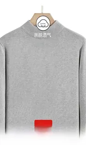 Detail view of cotton grey long-sleeved knit sweater with a semi-high collar and fine texture