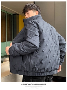 Detail of grey men's puffer jacket with diagonal quilting and embossed pattern