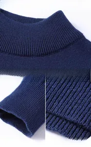 Detail view of navy ribbed knit fabric featuring mock neck, cuffs and elastic hemline