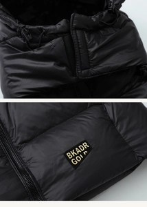 Detail view of the black down vest showing drawstring hood, zipper and gold label