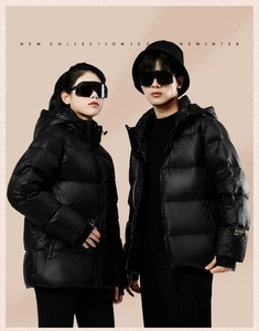 Studio shot of black hooded down jackets featuring letter embroidery and premium matte nylon
