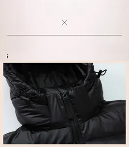 Detail of hooded black down jacket featuring metallic zipper and windproof glossy fabric