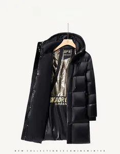 Detail of long black down jacket featuring a golden honeycomb textured thermal lining