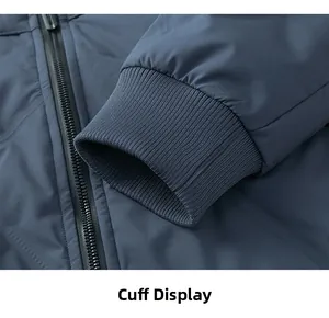 Detail view of the ribbed windproof cuff and waterproof zipper on blue down jacket