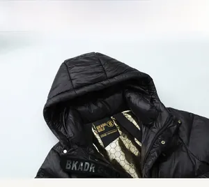Detail of black down jacket with tech-inspired golden honeycomb heat-reflective lining