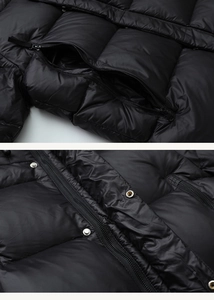 Detail der schwarzen Daunenjacke mit Steppstoff, Metallknöpfen und Nylon-Reißverschluss