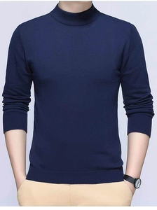 Detail of ribbed cuffs and hem on a men's navy blue mock neck knit sweater