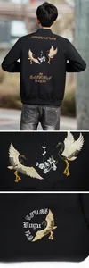 Detail of crane and floral embroidery on the back of a black men's bomber jacket