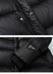Detail of windproof cuffs and heavy-duty zipper on black glossy quilted down jacket