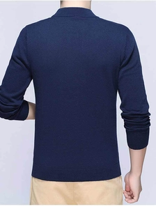 Detail view of the fine ribbed texture on dark blue men's knitted long sleeve sweater