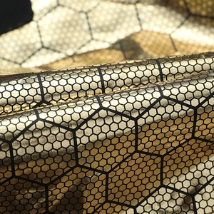 Unisex black gold down puffer vest with metallic honeycomb pattern and thick padded texture