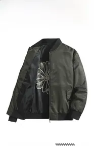 Detailed close-up of army green bomber jacket featuring floral lining and metal zipper