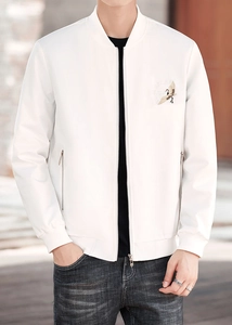 Close-up of white jacket featuring elegant crane embroidery and metallic zipper pocket