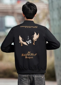 Detail of premium black bomber jacket featuring intricate crane and floral back embroidery
