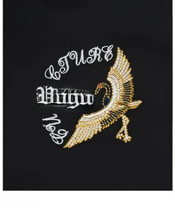 Detailed close-up of intricate crane embroidery on a black premium bomber jacket
