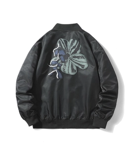 Detail view of the black bomber jacket back with artistic floral graphic and satin finish
