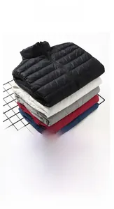 Close-up of lightweight down vests in multiple colors with matching portable storage bags