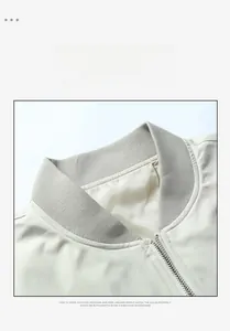 Detail of baseball collar jacket with silver metal zipper and cream ribbed knit fabric