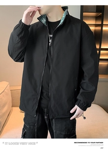 Detail of men's casual black jacket showing green lettering inside the collar and zipper