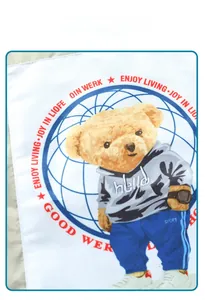 Close-up of baseball jacket lining with cartoon bear print and varsity lettering