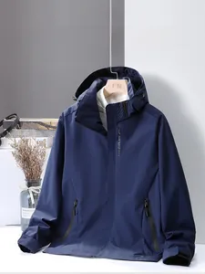 Detail view of navy blue hooded jacket featuring EXPLORE lettering and windproof fabric texture