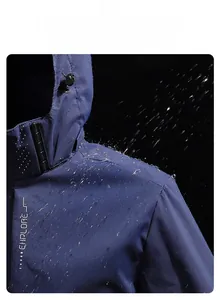 Close-up of waterproof fabric showing water beads on dark blue outdoor jacket