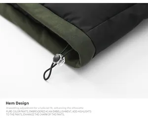 Detail of the adjustable drawstring hem with a transparent toggle on a green jacket