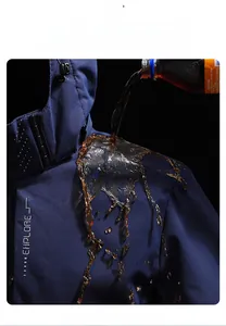 Macro detail showing water-repellent technology on dark blue outdoor jacket fabric