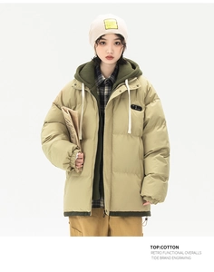 Detail of retro olive khaki padded parka with layered hood and functional drawstrings